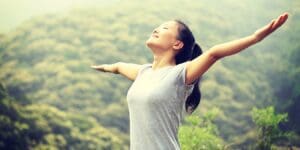 young asian woman breathing fresh air in sprijhgjghj