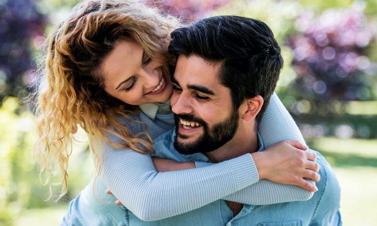 young woman hugging partner from behind 768